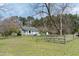 Charming home with a metal gate and a grassy yard at 1556 Pleasants Rd, Wendell, NC 27591
