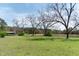 Lush green land with mature trees and a distant shed, offering privacy and natural beauty at 1556 Pleasants Rd, Wendell, NC 27591