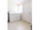 Bright laundry room featuring a classic white washer and dryer set and tiled floor at 1556 Pleasants Rd, Wendell, NC 27591