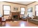 Cozy living room featuring a fireplace, wood floors, and bright natural light at 1556 Pleasants Rd, Wendell, NC 27591