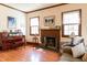 Inviting living room showcasing a fireplace, wood floors, and bright natural light at 1556 Pleasants Rd, Wendell, NC 27591