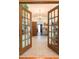 Living room with chandelier and glass doors leading to other rooms of the home at 1556 Pleasants Rd, Wendell, NC 27591