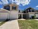 Modern townhome featuring a two-car garage and well-maintained lawn at 158 Parker Ln, Mebane, NC 27302