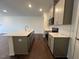 Modern kitchen featuring stainless steel appliances, island, and white countertops at 158 Parker Ln, Mebane, NC 27302