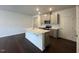 Open-concept kitchen with stainless steel appliances, island, and dark wood flooring at 158 Parker Ln, Mebane, NC 27302