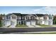 New construction townhomes lining the street, each with a garage and lawn at 158 Parker Ln, Mebane, NC 27302
