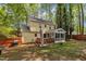 View of the home's backyard featuring a wooden deck and screened-in sunroom at 1600 S Wade Ave, Garner, NC 27529