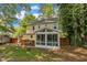 Shot of the backyard featuring a screened sunroom and wooden deck with ample green space at 1600 S Wade Ave, Garner, NC 27529