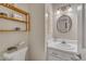 Cozy half bath features a stylish round mirror, modern lighting, and a white sink with ample counter space at 1600 S Wade Ave, Garner, NC 27529