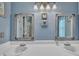 Bathroom featuring a double vanity with framed mirrors and modern lighting fixtures at 1600 S Wade Ave, Garner, NC 27529