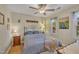 Cozy bedroom with a metal bed frame, side tables, lamps, ceiling fan, and natural light from two windows at 1600 S Wade Ave, Garner, NC 27529