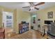 Bright room features a computer, ceiling fan, and a view into an adjacent bedroom, filled with natural light at 1600 S Wade Ave, Garner, NC 27529