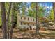 A yellow two-story home with a inviting front porch framed by mature trees at 1600 S Wade Ave, Garner, NC 27529