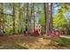 Yellow two-story home with mature trees and a landscaped yard at 1600 S Wade Ave, Garner, NC 27529