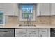 Kitchen sink featuring a modern faucet, bright lighting, and a clean design with neutral backsplash at 1600 S Wade Ave, Garner, NC 27529