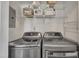 Well-organized laundry area features a washer, dryer, and shelving for efficient storage and laundry management at 1600 S Wade Ave, Garner, NC 27529