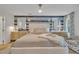 Comfortable main bedroom with modern furniture, including a large bed, side tables, and decorative wallpaper at 1600 S Wade Ave, Garner, NC 27529