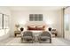Stylish bedroom boasts decorative art, cozy seating, and a comfortable bed with decorative pillows at 1653 Goldfinch Perch Ln, Knightdale, NC 27545