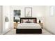 Well-lit bedroom featuring a comfortable bed, side tables, and inviting decor at 1653 Goldfinch Perch Ln, Knightdale, NC 27545