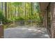 Backyard wooden deck with chairs surrounded by trees at 1705 Lord Ashley Dr, Sanford, NC 27330