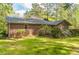 Backyard of a brick house with a wooden staircase and grassy yard at 1705 Lord Ashley Dr, Sanford, NC 27330