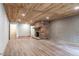Spacious basement area with wood plank ceiling, brick fireplace, and painted brick accent wall at 1705 Lord Ashley Dr, Sanford, NC 27330