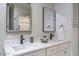 Bathroom featuring dual sinks, white cabinets, and walk-in shower at 1705 Lord Ashley Dr, Sanford, NC 27330