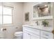 Bathroom features single sink vanity, framed mirror, and toilet with a tile shower at 1705 Lord Ashley Dr, Sanford, NC 27330