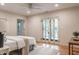Bedroom with hardwood floors, bright natural light, and access to an outdoor patio at 1705 Lord Ashley Dr, Sanford, NC 27330