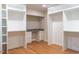 Bright closet with built-in shelving, drawers, desk, and wood flooring at 1705 Lord Ashley Dr, Sanford, NC 27330