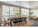 Bright dining room with large windows, a modern chandelier, and ample seating at 1705 Lord Ashley Dr, Sanford, NC 27330