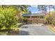 Welcoming home featuring a balcony, double garage, and well-maintained driveway, surrounded by blooming trees and greenery at 1705 Lord Ashley Dr, Sanford, NC 27330
