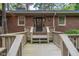 Front entrance features a ramp and brick exterior, with trimmed windows and natural light at 1705 Lord Ashley Dr, Sanford, NC 27330