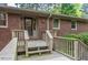 Charming brick home featuring a covered front porch and well-maintained landscaping at 1705 Lord Ashley Dr, Sanford, NC 27330