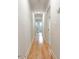 Bright hallway with wood flooring leading to the bathroom at 1705 Lord Ashley Dr, Sanford, NC 27330