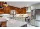 Updated kitchen featuring granite countertops, stainless steel appliances, and wood cabinets at 1705 Lord Ashley Dr, Sanford, NC 27330