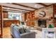 Living room features brick fireplace, wood beams, built-in shelving, and bar that opens to kitchen at 1705 Lord Ashley Dr, Sanford, NC 27330