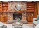 Charming living room with a brick fireplace, wooden shelves, and modern furniture at 1705 Lord Ashley Dr, Sanford, NC 27330