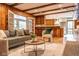 Living room that opens to kitchen, featuring exposed wood beams and hardwood floors at 1705 Lord Ashley Dr, Sanford, NC 27330