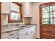 Well-lit mudroom with granite countertops, white cabinets, and a convenient exterior door at 1705 Lord Ashley Dr, Sanford, NC 27330