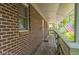 Long brick porch with American flag in the background at 1705 Lord Ashley Dr, Sanford, NC 27330