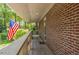Long brick porch with American flag in the background at 1705 Lord Ashley Dr, Sanford, NC 27330
