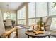 Relaxing area with modern seating, views of outdoors through multiple windows, and a small table at 1705 Lord Ashley Dr, Sanford, NC 27330