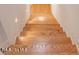 Classic staircase with wooden steps and white painted walls at 1705 Lord Ashley Dr, Sanford, NC 27330