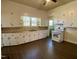 Classic kitchen with white cabinets, a double sink, and a new stove at 1716 Turner St, Roxboro, NC 27573