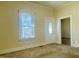 Living room featuring a door to the exterior, carpet flooring and lots of natural light from large windows at 1716 Turner St, Roxboro, NC 27573
