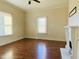 Living room featuring a fireplace with white trim, hardwood floors and lots of natural light from large windows at 1716 Turner St, Roxboro, NC 27573