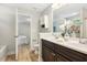 Bright bathroom featuring a tub and shower combo, double vanity, and adjoining bedroom at 1817 Heisser Ln, Fuquay Varina, NC 27526