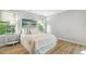 Bright bedroom with hardwood floors, a decorative painting, and natural light streaming through the window at 1817 Heisser Ln, Fuquay Varina, NC 27526