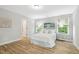 Bright bedroom with wood floors, two windows, neutral walls, and modern décor at 1817 Heisser Ln, Fuquay Varina, NC 27526